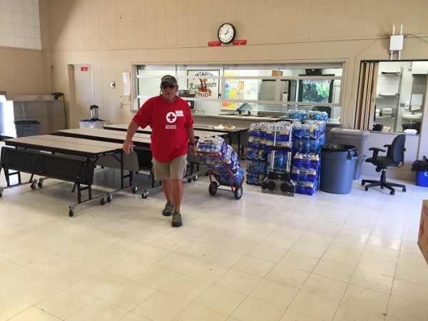 Red Cross volunteer Patrick Sayne helps organize the shelter for Cuesta Fire evacuees in Atascadero. The site is at the Santa Rosa Academic Academy elementary school.   Photo by Paula McCambridge