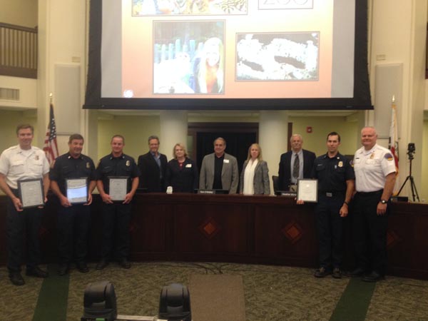 The honored firefighters display their plaques. 