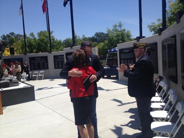 Veteran Jonny Benton hugs Ann Hatch.