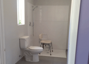 Jocelyn Dyer's renovated bathroom, which allows for her wheelchair to be pushed directly into the shower and transferred to the shower chair. Photo courtesy of Jennifer Dyer