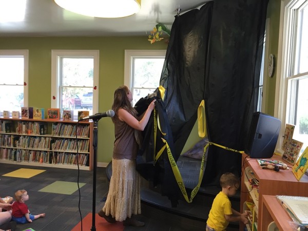 Artist Lauren Birkhahn unveils a special piece of art she created for the Atascadero Library's children's section.  Photo by Paula McCambridge