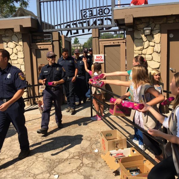 Girl Scout Cadets handing cookie boxes to firefighters heading off to a long day of work. Photo contributed by Christy Little.