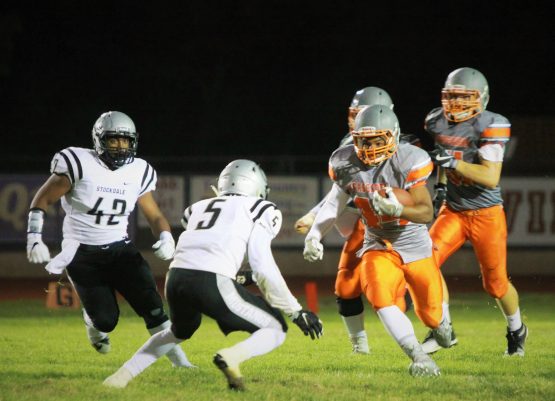 Kobe Cross, followed by his teammates, attempts to break through Stockdale's defense.