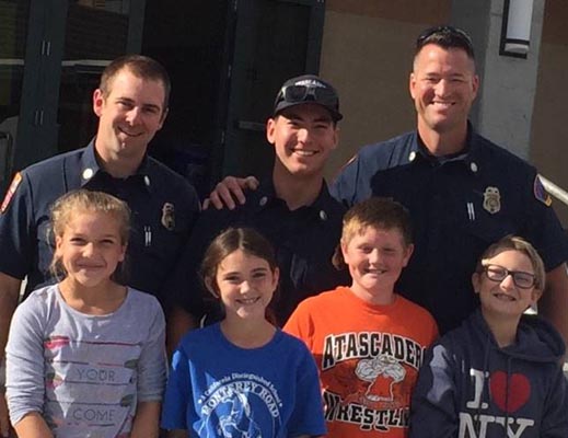 Pictured are students from the Monterey Road Elementary School 5th Grade Student Council and members of the Atascadero Fire and Emergency Services. The Student Council are, from left to right, Carly Evans, Lauren Smith, Brad Capriotti and Jaden Taylor. Firefighters from left to right, Engineer/Paramedic Chris Robinson, Seasonal Firefighter Nathan Goossens and Fire Captain/Paramedic Bill White.