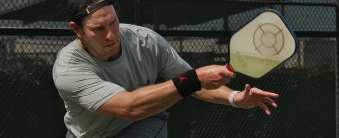 A man plays pickleball