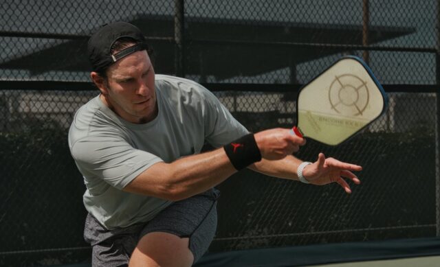 A man plays pickleball