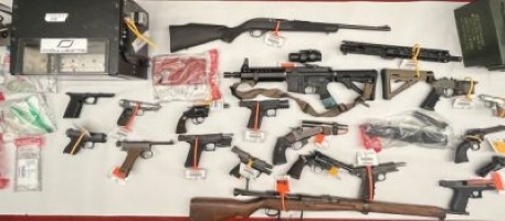 Felon arrested for possession of 24 firearms, ammo, explosive device