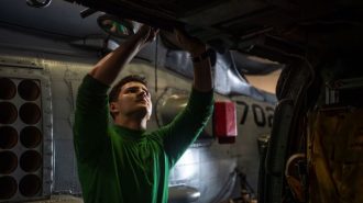 Atascadero native conducts helicopter maintenance in the hangar bay aboard USS Nimitz