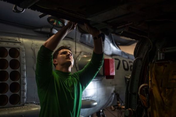 Atascadero native conducts helicopter maintenance in the hangar bay aboard USS Nimitz