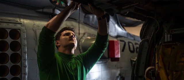 Atascadero native conducts helicopter maintenance in the hangar bay aboard USS Nimitz