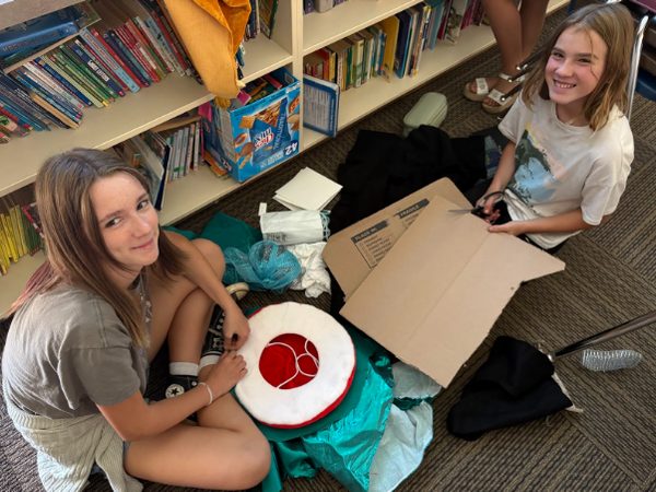 Atascadero Fine Arts Academy students smile while creating their own costumes