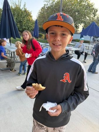 A Monterey Road Elementary student enjoys a treat at Mustang Morning
