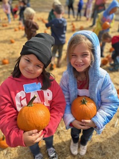 Monterey Road Elementary first graders holding pumpkins from Avila Valley Barn
